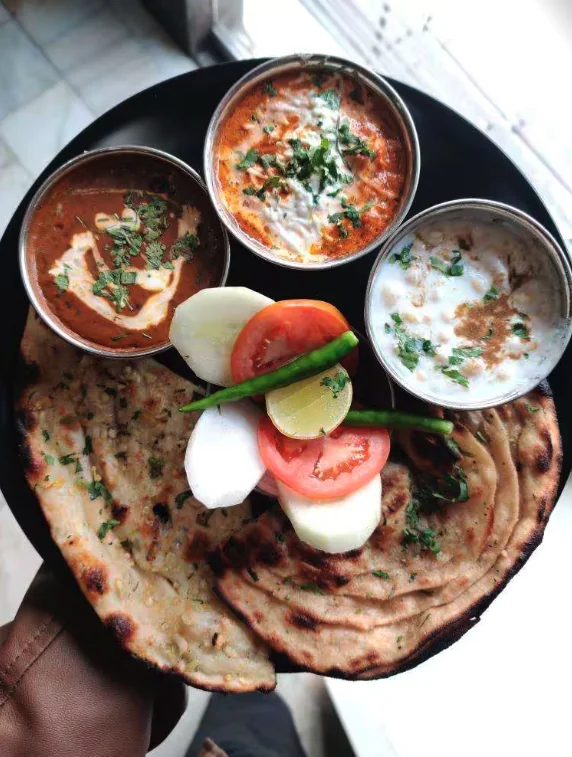 Dal makhani, paneer, raita and paranthas served at Chotiwala