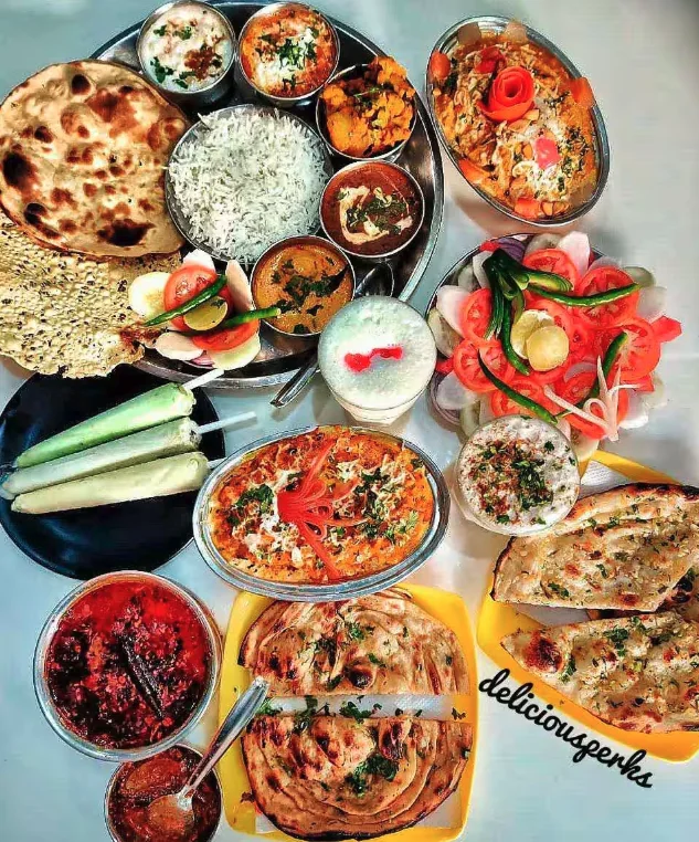 A spread at Chotiwala: thali, paneer, dal, naan, lachha parantha, lassi and salad